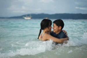 Romantic honeymoon couple swimming in crystal-clear waters of Komodo Islands