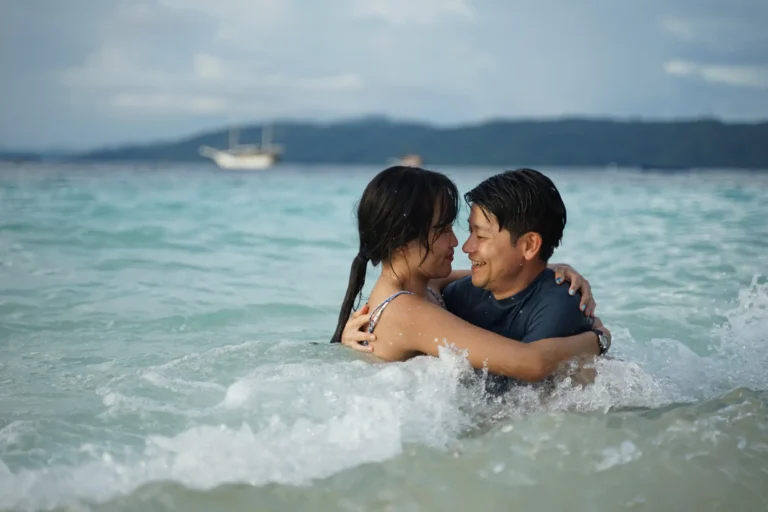 Romantic honeymoon couple swimming in crystal-clear waters of Komodo Islands