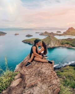 Couple enjoying a romantic moment on Padar Island viewpoint in Komodo National Park, Labuan Bajo Indonesia during a honeymoon and luxury island adventure trip.