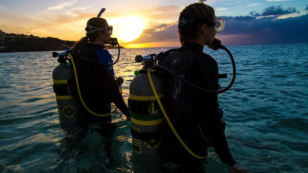 Honeymoon Diving Experience Labuan Bajo aboard a luxury phinisi boat with romantic sunset, crystal clear water, Komodo Island diving, and tropical island adventure.
