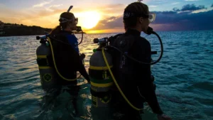 Honeymoon Diving Experience Labuan Bajo aboard a luxury phinisi boat with romantic sunset, crystal clear water, Komodo Island diving, and tropical island adventure.