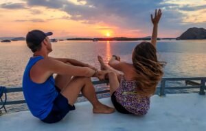 Romantic sunset cruise in Labuan Bajo, Flores Island Indonesia with couples enjoying peaceful ocean views during a Komodo Island boat trip adventure | visitlabuanbajokomodo.com