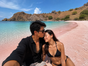 Romantic Labuan Bajo honeymoon couple at Pink Beach Komodo Island enjoying tropical vacation with Visit Labuan Bajo Komodo private trip experience.