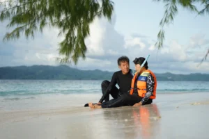 Couple enjoying a relaxing snorkeling experience on a pristine tropical beach in Labuan Bajo, Indonesia, during a private Komodo Island tour with Visit Labuan Bajo Komod