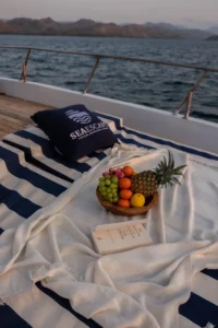 Fresh tropical fruit platter served on luxury yacht in Labuan Bajo during Komodo Island cruise by Visit Labuan Bajo Komodo.