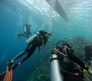 Scuba divers exploring the underwater world of Komodo National Park during a dive course in Labuan Bajo with Visit Labuan Bajo Komodo.