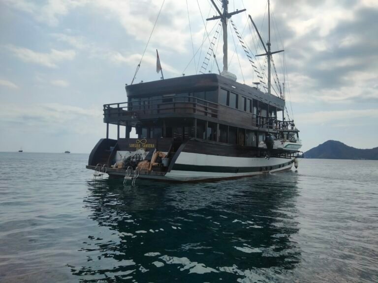 Luxury Phinisi boat sailing in Komodo National Park near Labuan Bajo, Flores, Indonesia during a scenic island-hopping adventure.