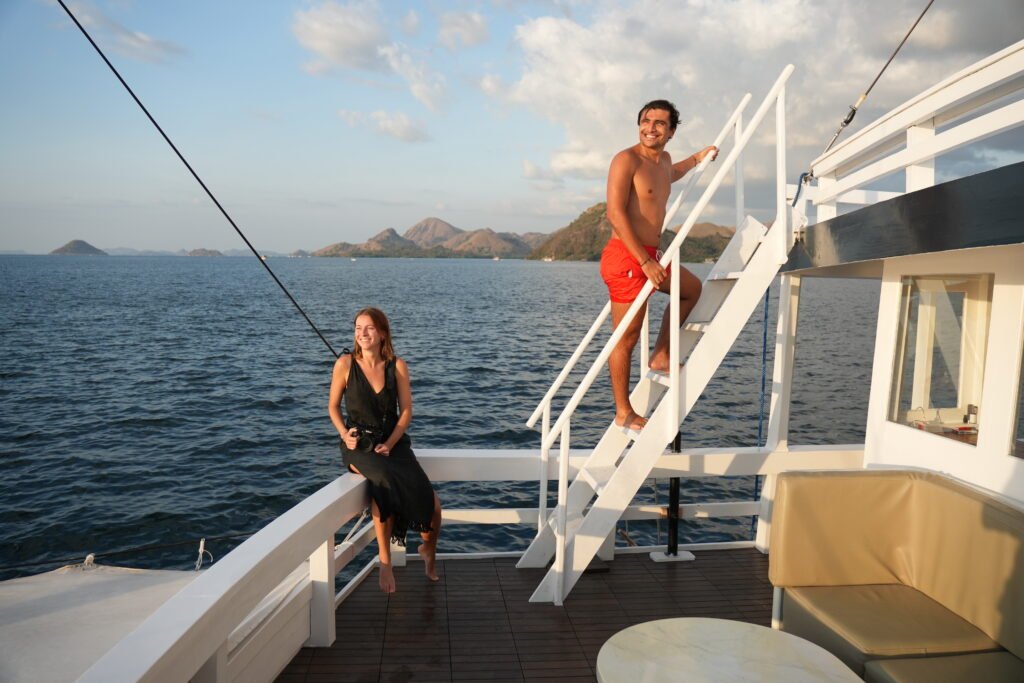 Travelers enjoying a boat cruise with scenic islands near Labuan Bajo, Indonesia.